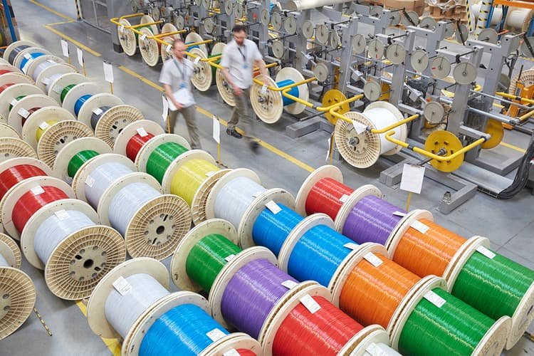 Colorful spools of optic cables in a factory
